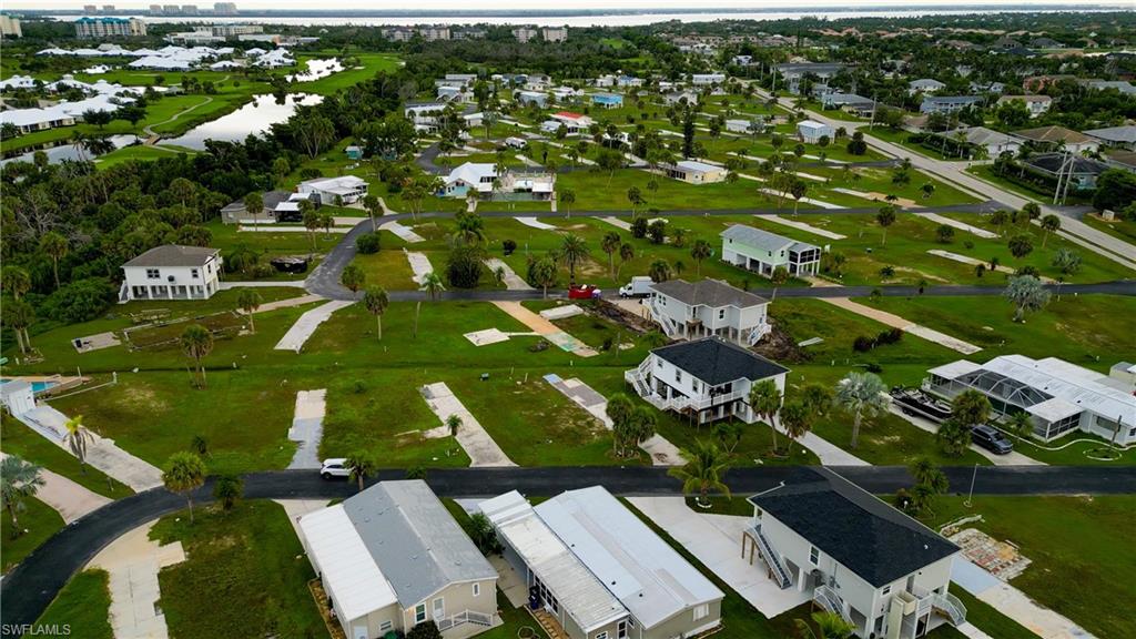 Aerial overview of property's location with nearby suburban area and a large body of water