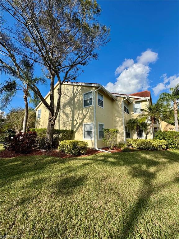 View of home's exterior featuring stucco siding and a lawn