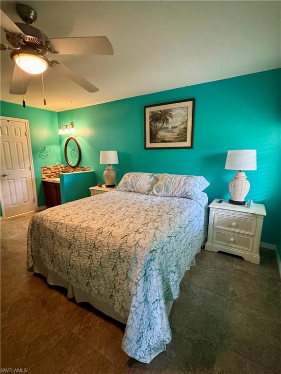 Bedroom with ceiling fan and connected bathroom