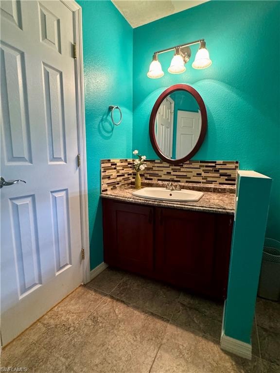 Primary bath featuring vanity, tasteful backsplash