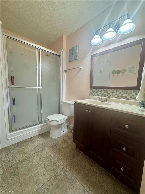 Bathroom with vanity, a textured ceiling, a stall shower, and tasteful backsplash