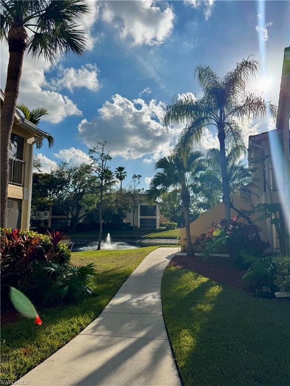 View of home's community with a yard