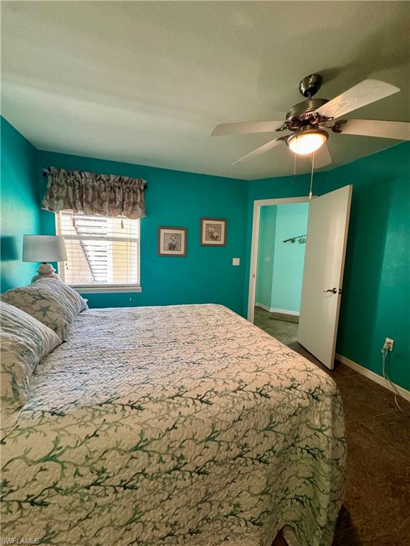 Bedroom with baseboards and a ceiling fan