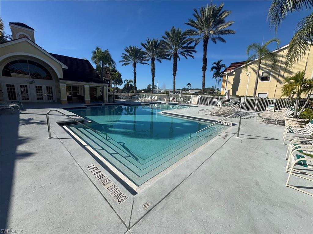 Community pool with a patio