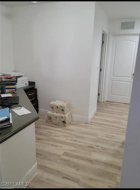 Office featuring light wood-style floors and baseboards