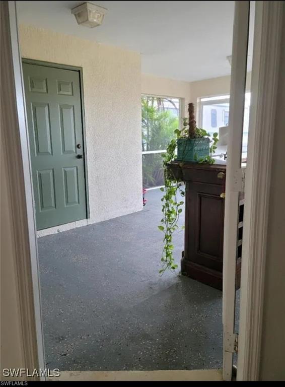 Entrance to property featuring stucco siding