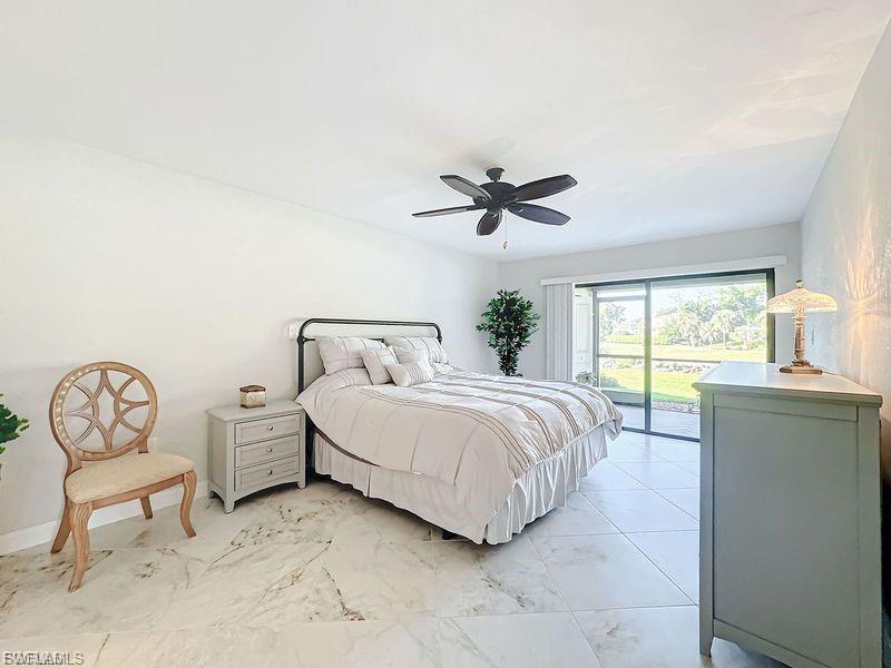 Bedroom featuring access to exterior and a ceiling fan