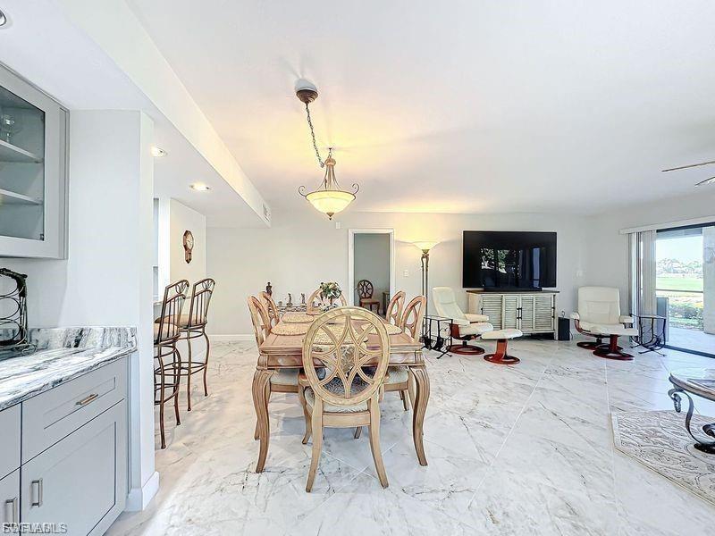 Dining room with light marble finish flooring