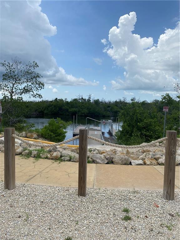 Water view with a dock and a boat ramp