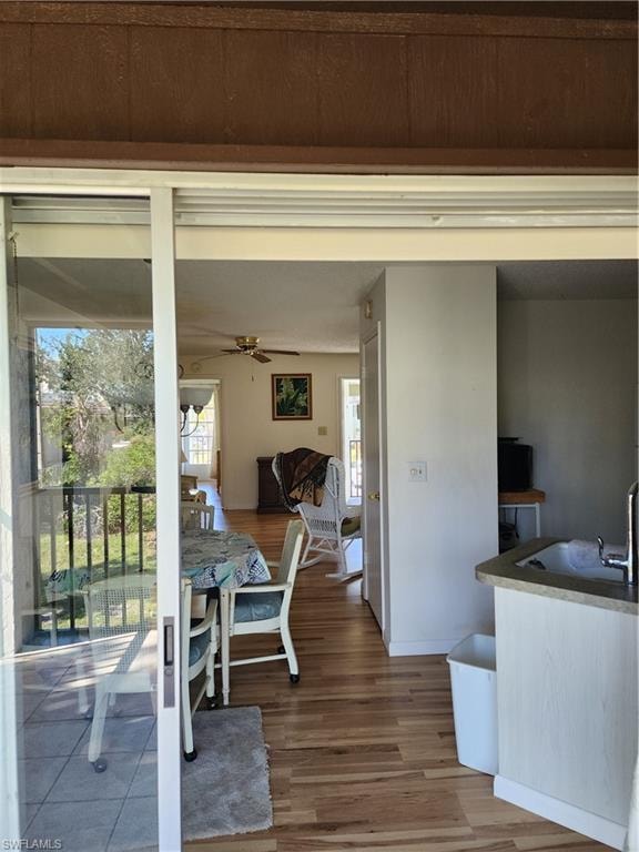 Dining space featuring wood finished floors and a ceiling fan
