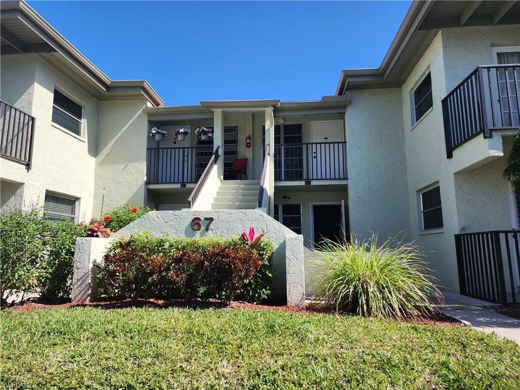 View of apartment building / complex with stairs
