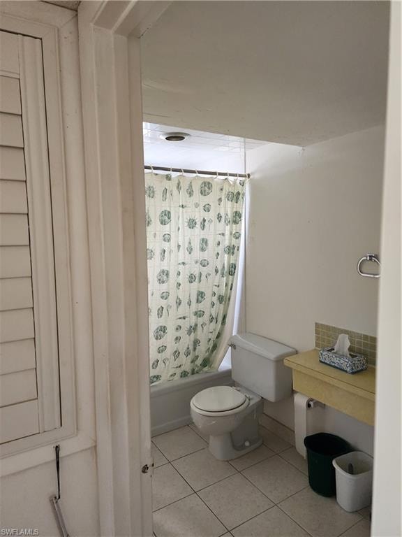 Full bathroom featuring shower / bath combo and light tile patterned floors