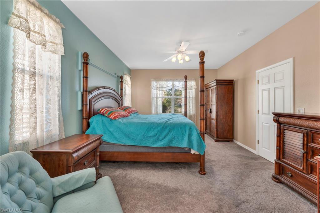 Primary Bedroom featuring carpet flooring and ceiling fan