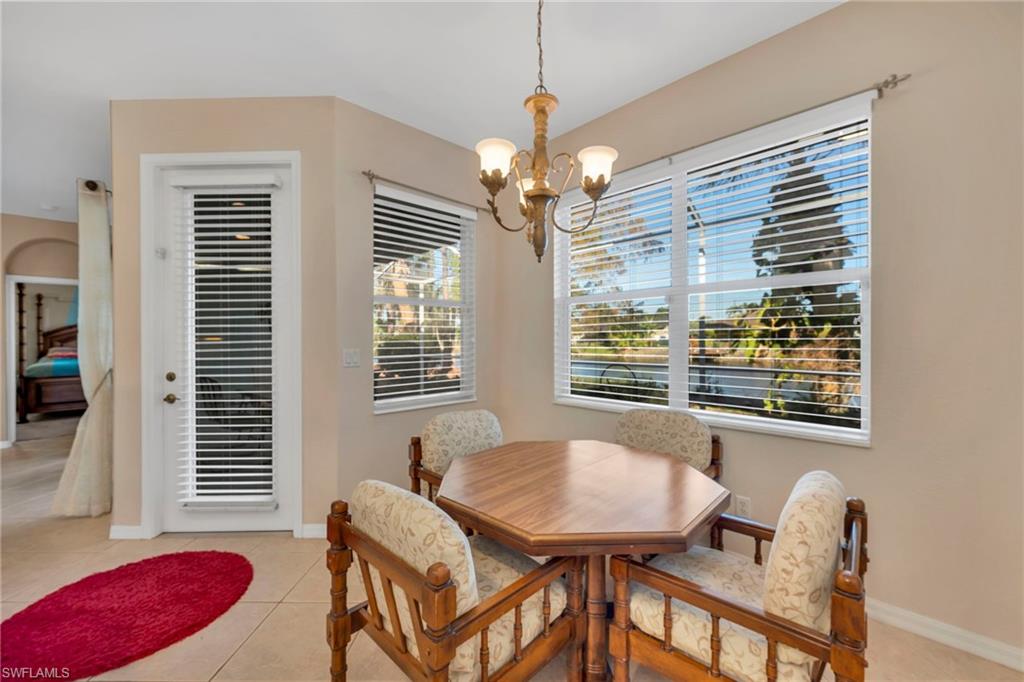 Breakfast area with door to Lanai, a chandelier and light tile patterned floors