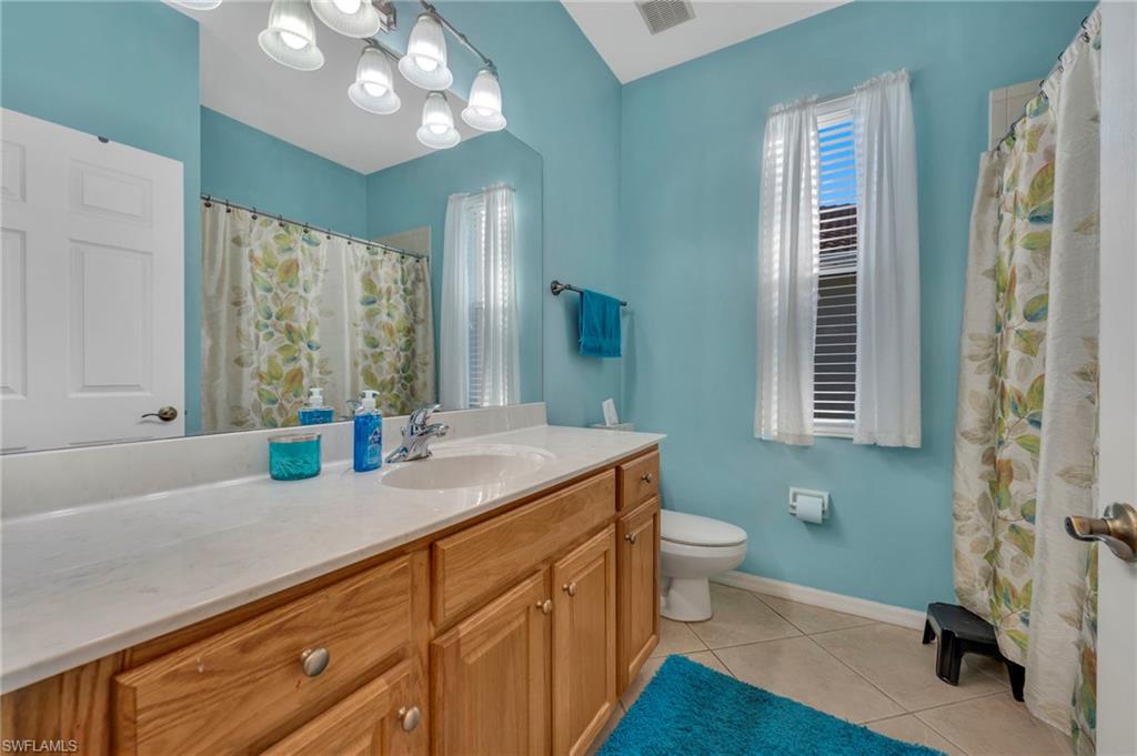 Full bathroom with vanity, a tub/shower combo, and light tile patterned floors