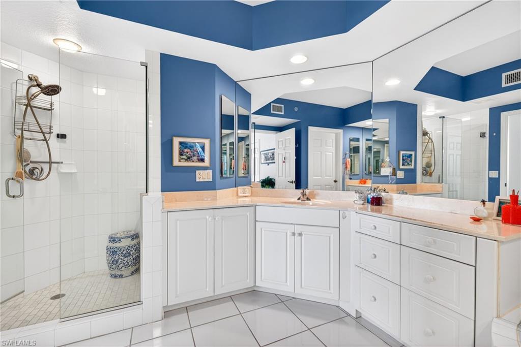 Full bathroom featuring a shower stall, vanity, light tile patterned flooring, and recessed lighting