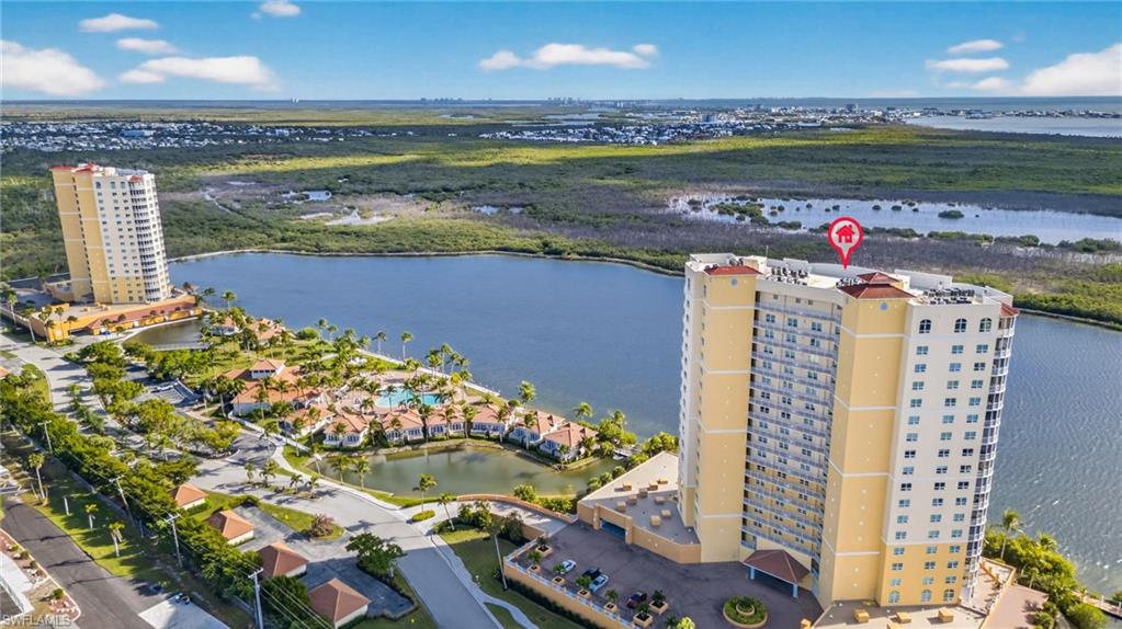 Aerial view of apartment complex and a large body of water