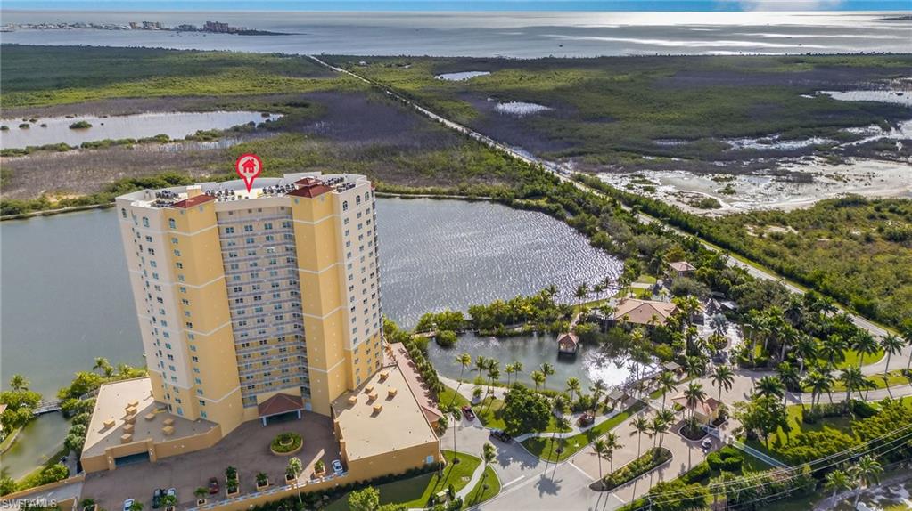 Aerial view of a large body of water and apartment complex / building