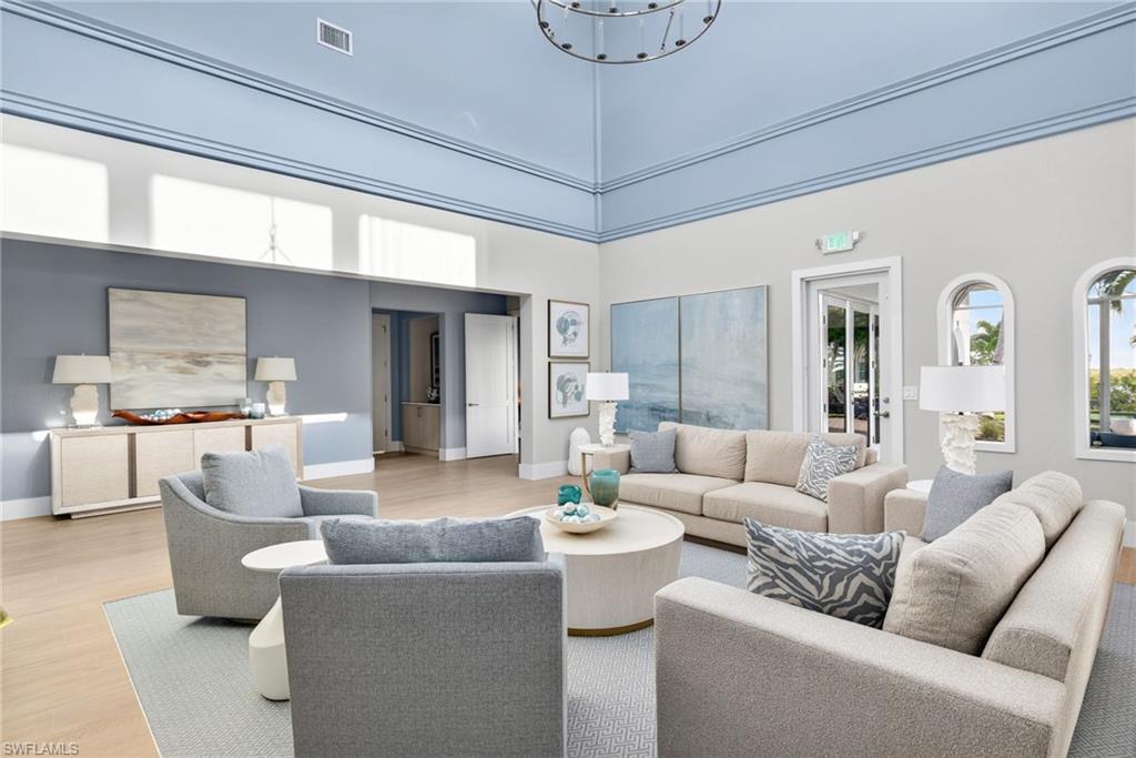 Living room featuring a high ceiling and wood finished floors