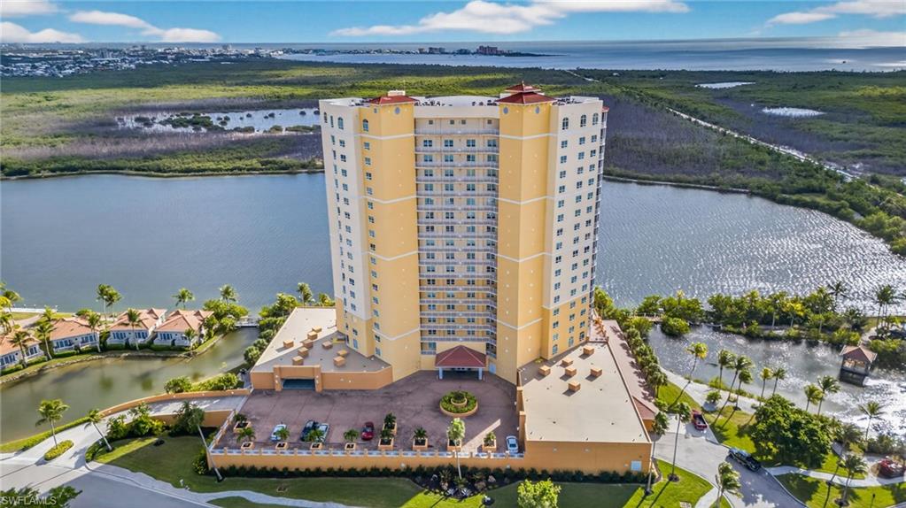Drone / aerial view of apartment complex / building and a nearby body of water