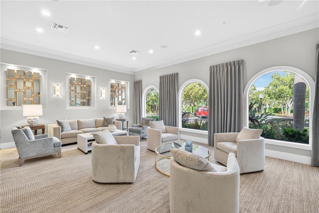 Carpeted living room featuring recessed lighting and ornamental molding
