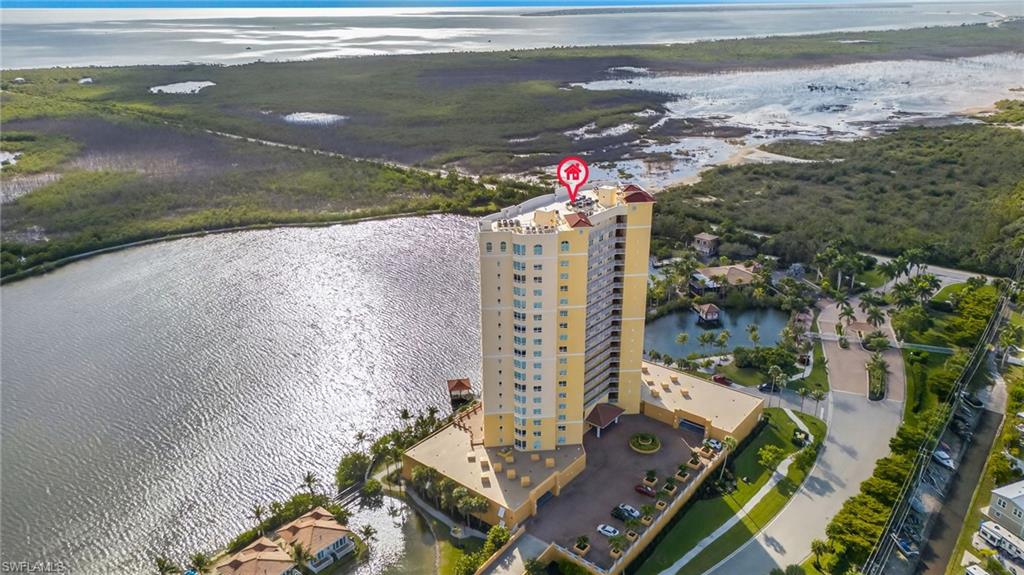Aerial view of a large body of water and apartment complex / building