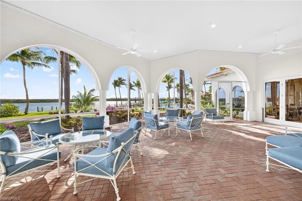 View of patio / terrace with a ceiling fan, a water view, and outdoor dining space