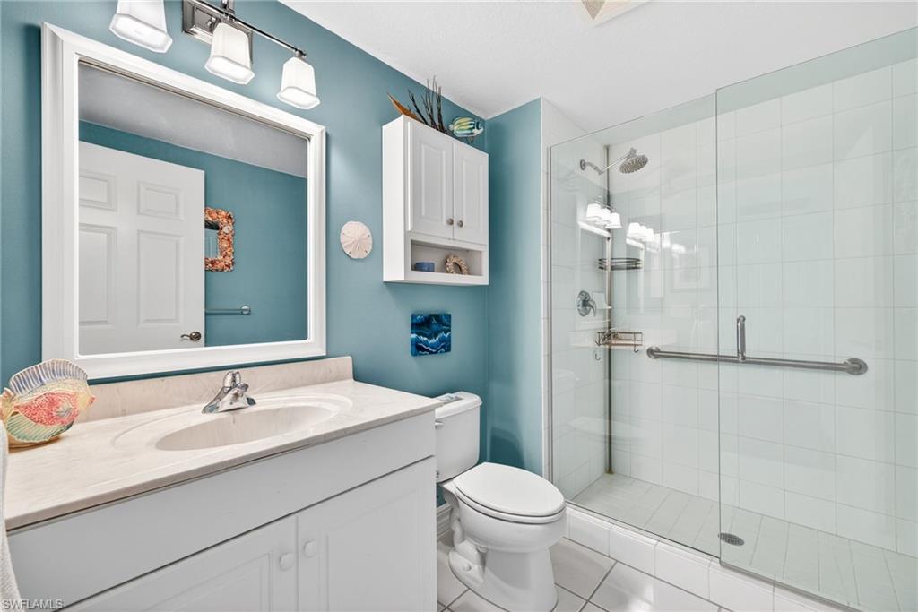 Bathroom featuring vanity, a stall shower, and light tile patterned flooring