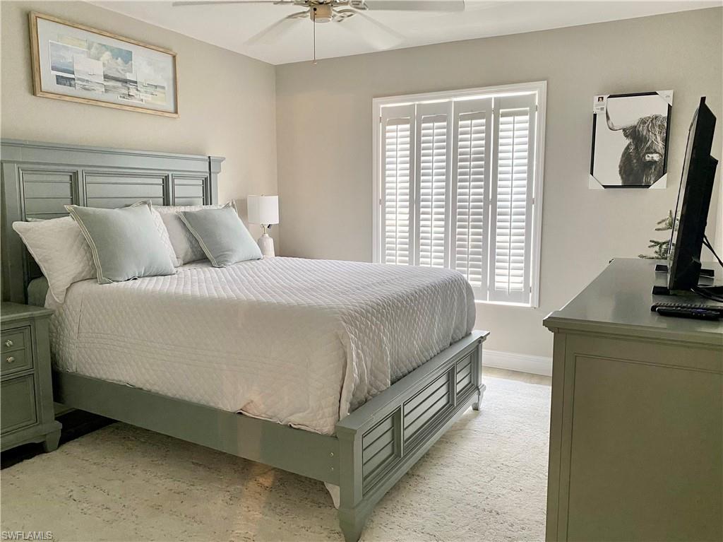 Guest bedroom featuring ceiling fan and queen size bed