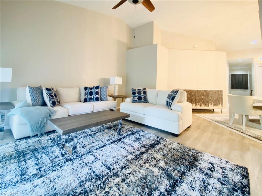 Living room with hardwood / wood-style flooring and ceiling fan
