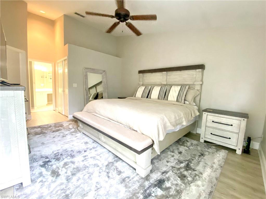 Main Bedroom with ceiling fan, ensuite bathroom, and light hardwood / wood-style flooring and king size bed
