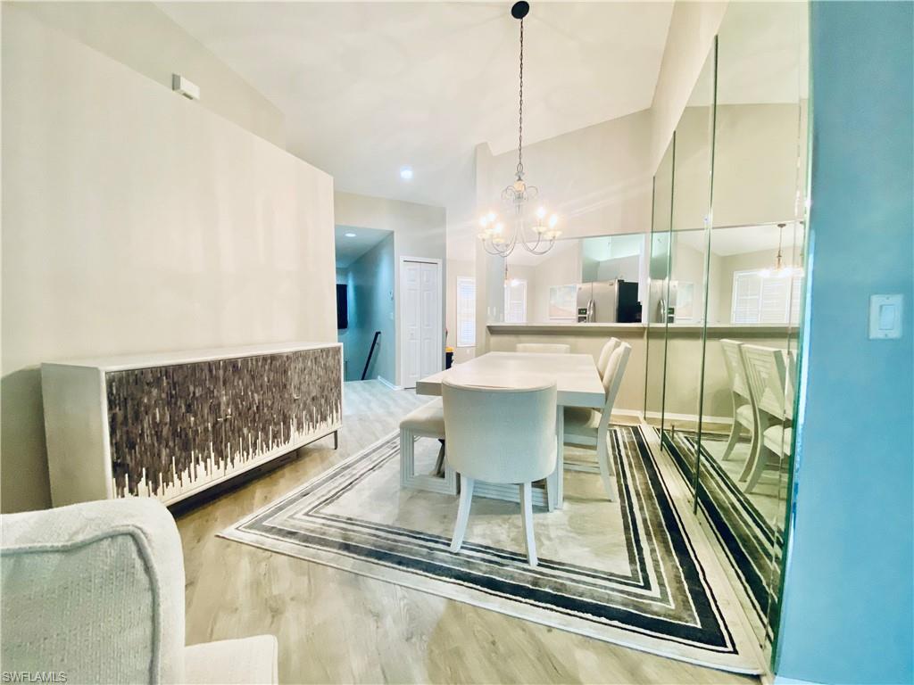Dining space featuring a notable chandelier and hardwood / wood-style floors