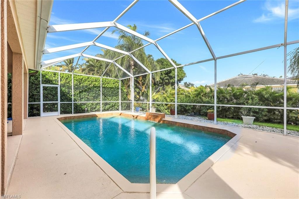 Swimming pool with a sunroom, a lanai, and a patio area
