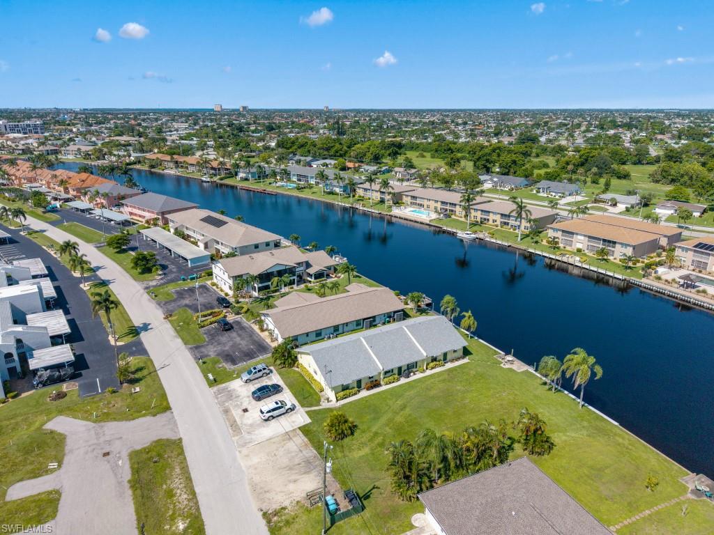 Aerial view of property and surrounding area with nearby suburban area