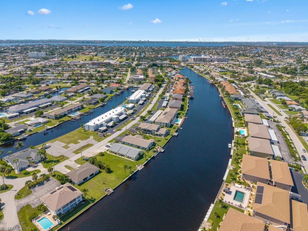 Aerial overview of property's location with a nearby body of water and nearby suburban area