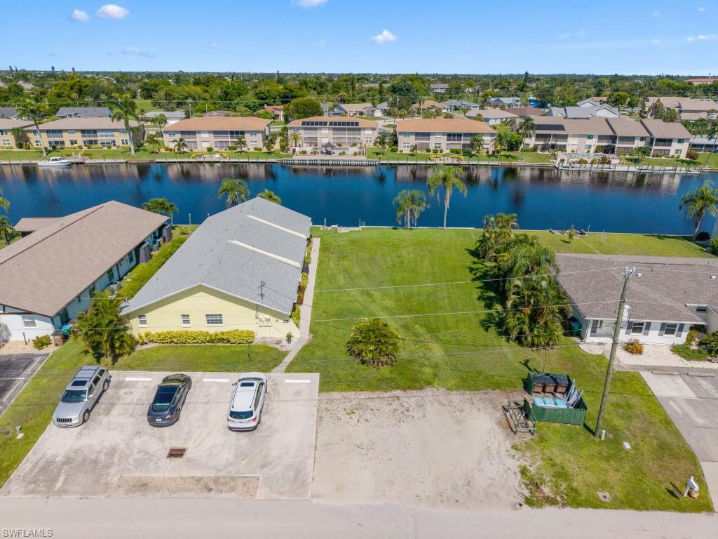 Aerial perspective of suburban area featuring a large body of water