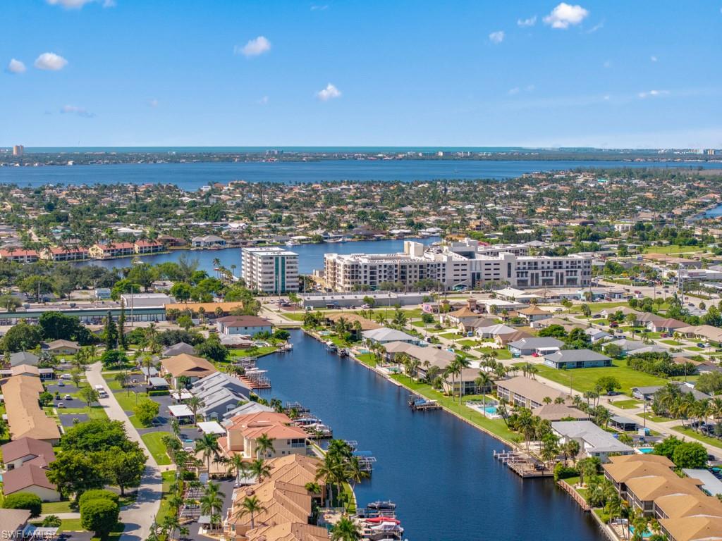 Aerial perspective of suburban area featuring a large body of water