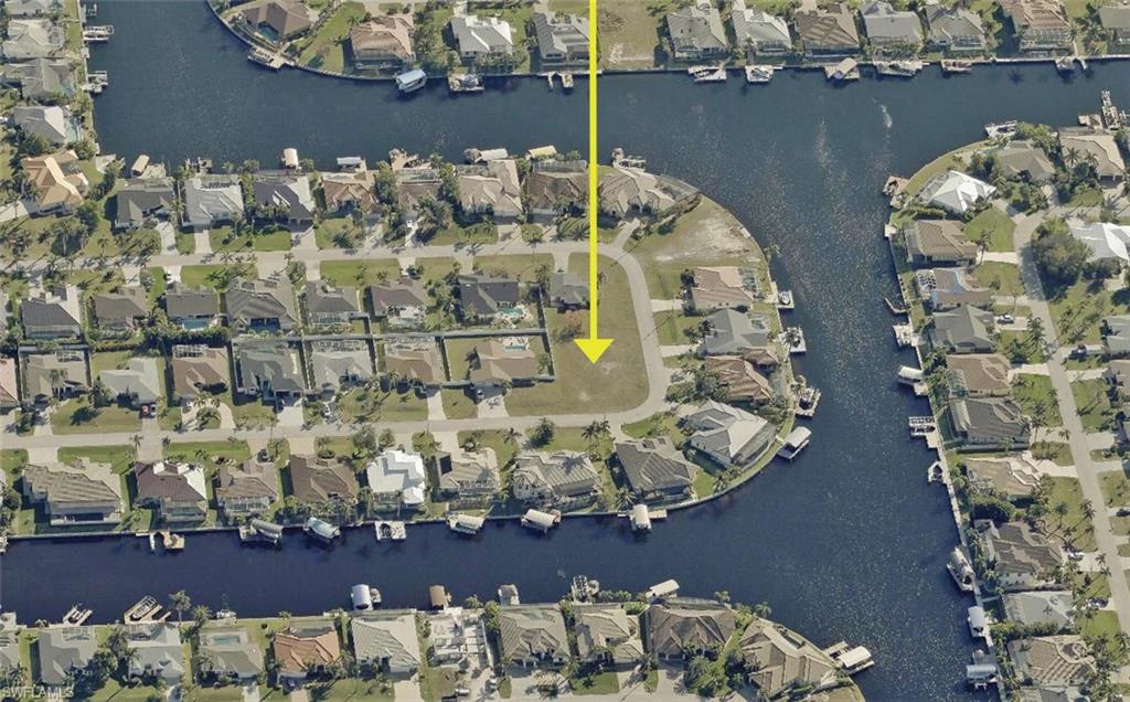 Aerial view of property's location with nearby suburban area and a large body of water
