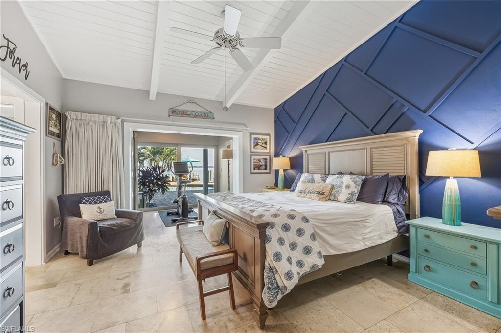 Bedroom featuring access to outside, a ceiling fan, an accent wall, a decorative wall, and beam ceiling