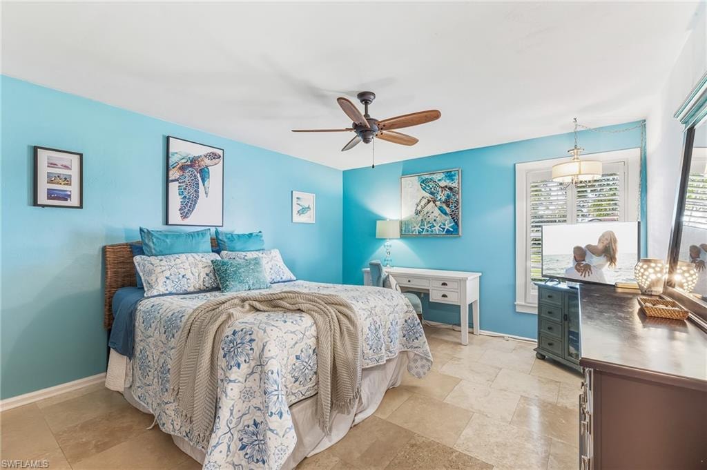 Bedroom with a ceiling fan and baseboards