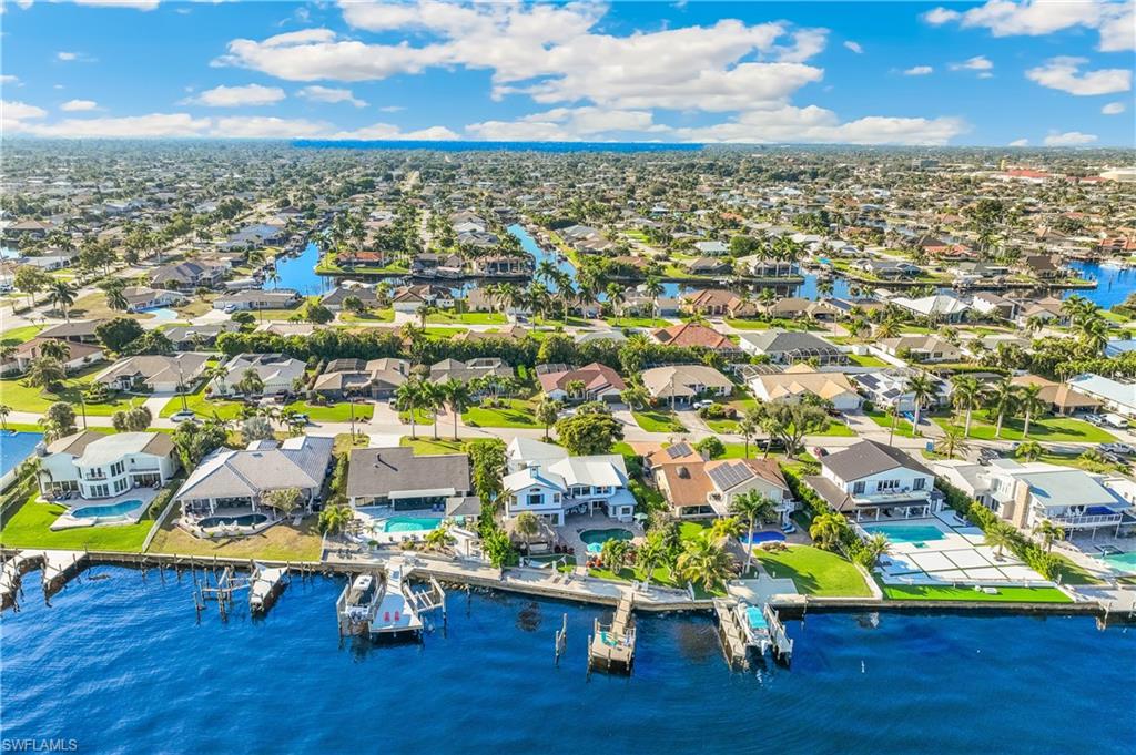 Aerial view of residential area featuring a large body of water