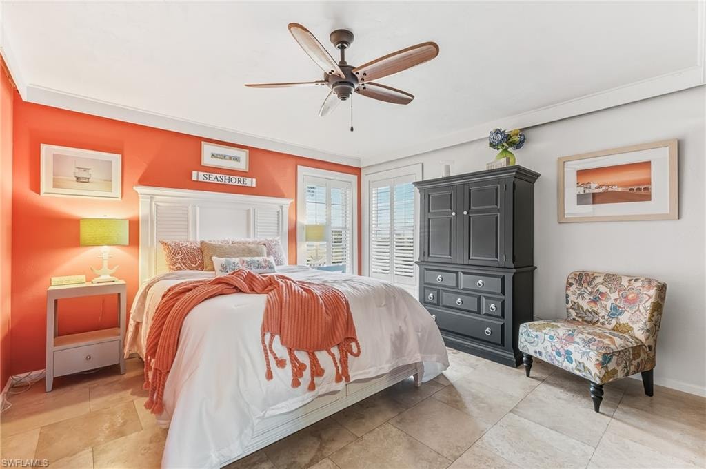 Bedroom with a ceiling fan and baseboards