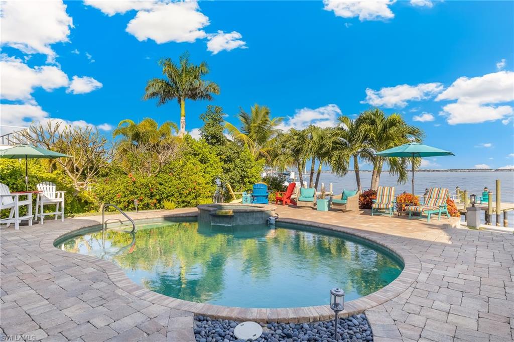 View of swimming pool with a patio and a pool with connected hot tub