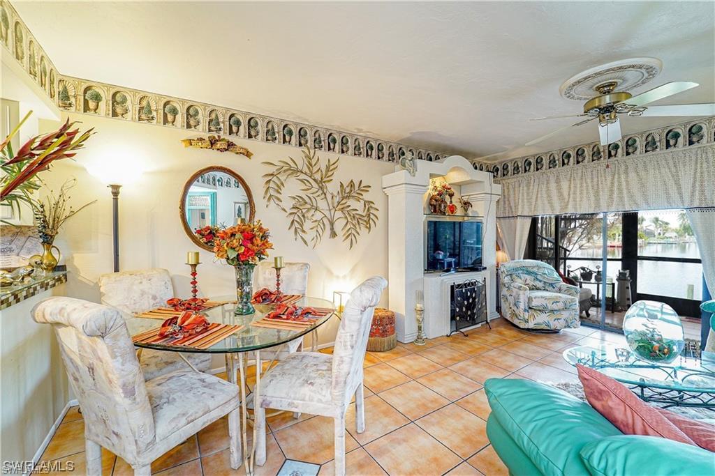 Dining area featuring tile patterned floors and a ceiling fan