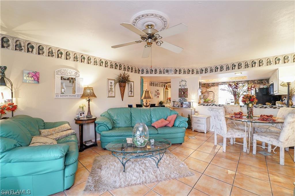 Tiled living room with a ceiling fan