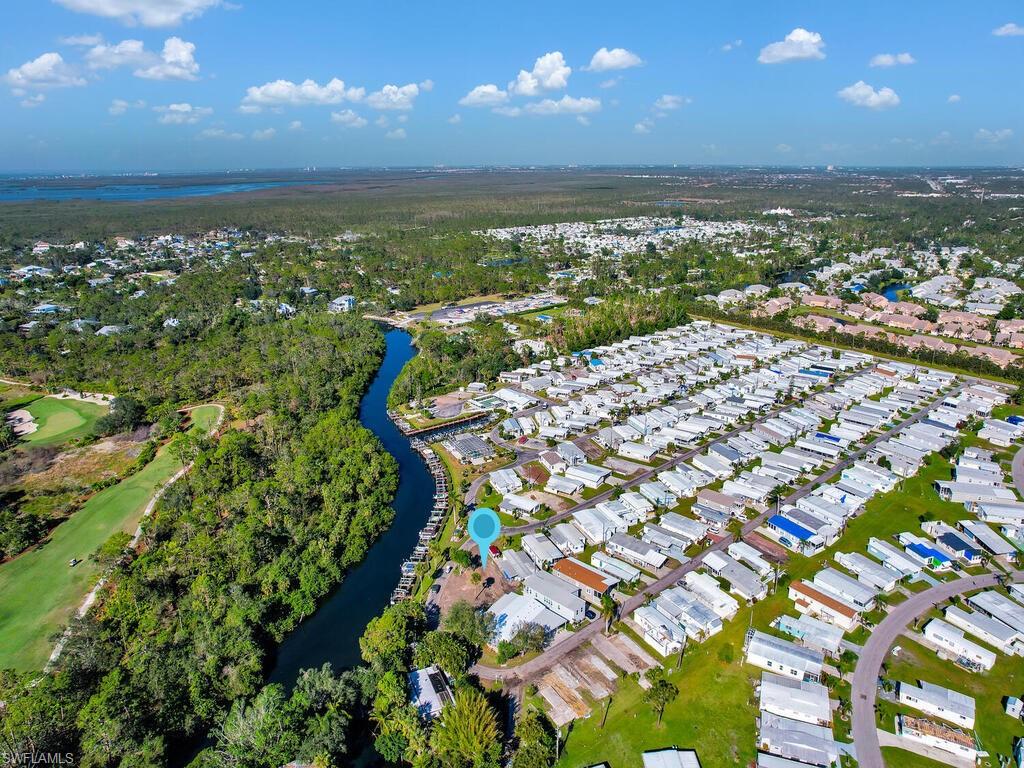 View of property location featuring a large body of water and nearby suburban area