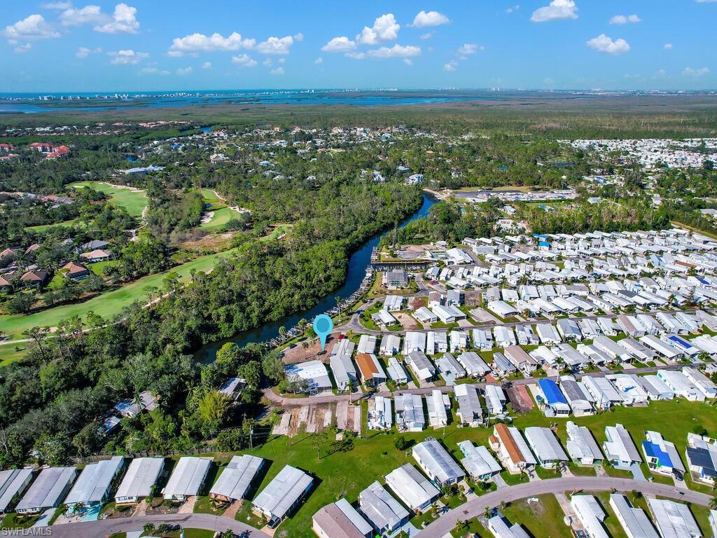 Aerial view of property's location featuring nearby suburban area and a nearby body of water