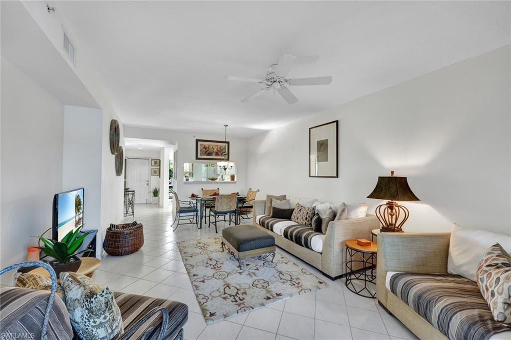 Living area with light tile patterned floors and a ceiling fan