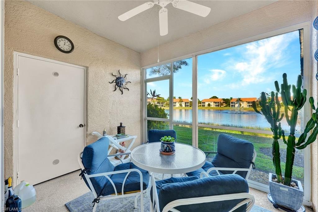 Screened in lanai with a water view and a textured wall