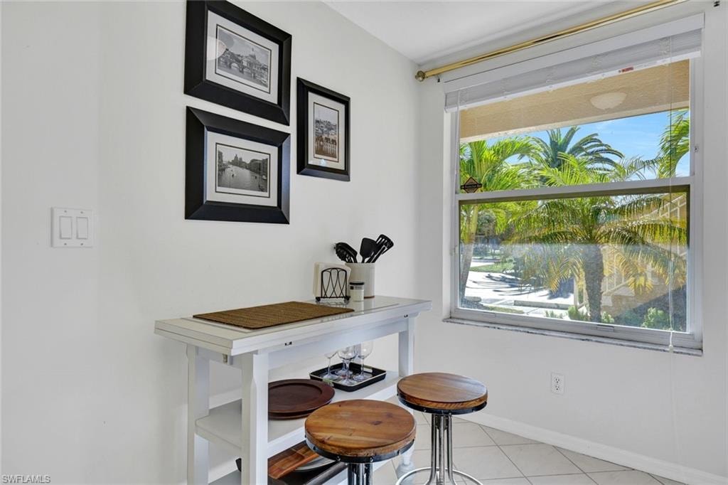 Kitchen breakfast nook featuring light tile patterned floors and baseboards